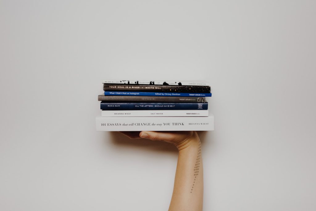 Person holding pile of books